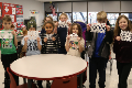 students holding paper snowflakes