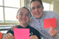 students holding positive letters