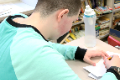 student writing thank you card