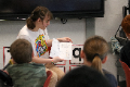 high school student reading to elementary students
