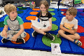 second grade student reading to pre k students