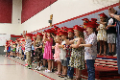 kindergarten students singing at their graduation ceremony 