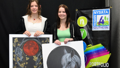 students holding artwork