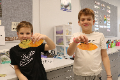 students holding up gratitude leaves