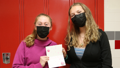 students holding valentines day cards