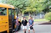 group of students walking away from school bus