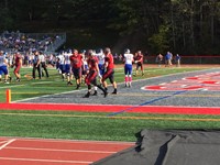 football players in the end zone at homecoming game