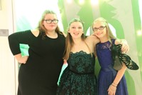 three female students smile for picture at homecoming