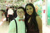 male and female student smile for a picture at homecoming dance