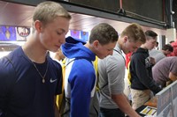students browse pamphlets at college day