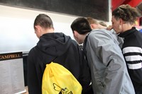 students look at table of pamphlets at college day