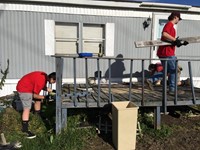 chenango valley students remove old boards from deck to begin new construction for ramp it up projec