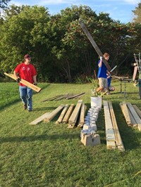 students move strips of wood for ramp it up project