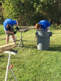 students remove nails from wood board for ramp it up project