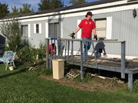 wide shot of students preparing for ramp it up project by removing old deck