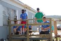 group working together on building deck