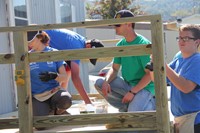 students and member of hillcrest rotary building deck