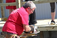 man using saw to cut wood