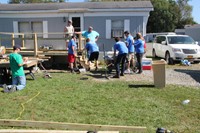 far shot of group working on digging