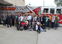 group posing in front of fire truck at binghamton fire department