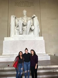 students in front of statue of abraham lincoln