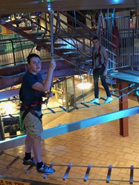 two male students on a rope course at destiny u s a mall