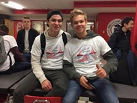 two male students smile for a picture in high school cafeteria