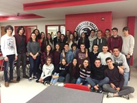 french exchange students smile for a picture in high school cafeteria