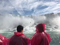 students on maid of the mist with niagra falls right in front of them