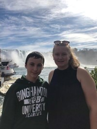 students smile in front of niagra falls