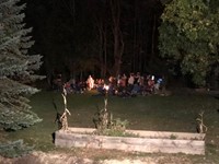 students at campfire outside