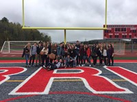 french exchange students as a group on warrior stadium field