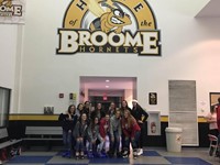 students at suny broome under sign that says home of the broome hornets