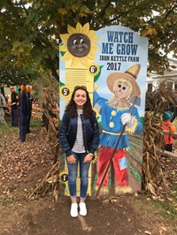 student at growth chart at iron kettle pumpkin farm