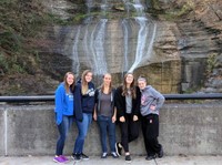 students pose in front of falls