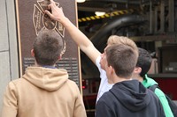 students looking at plaque at binghamton fire department