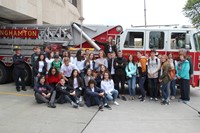students and teachers in front of fire truck