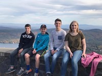 students in front of scenery of mountains in the background