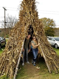 students in corn hut