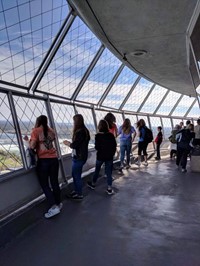 students look into distance from inside tower