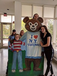 students pose with bear cut out