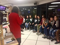 students talk to women in control room