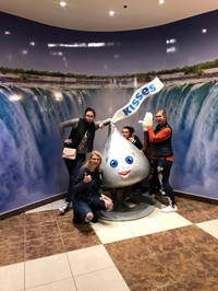 students pose with giant hershey kiss