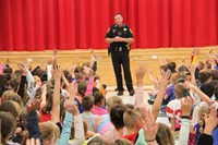 students raise their hands to answer deputy stapletons question
