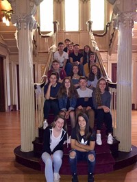 students sitting on stairs at roberson mansion