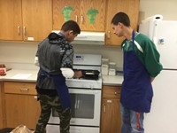 students work on grilling grilled cheese on stove top