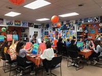 large group of students take part in painting class