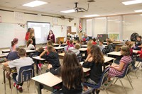 french exchange students talk to classroom of students