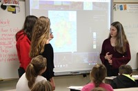 up close of students pointing to map of france on board