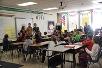 french students answer questions in elementary classroom